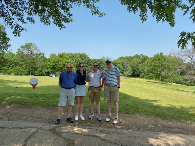 A foursome of golfers on the course