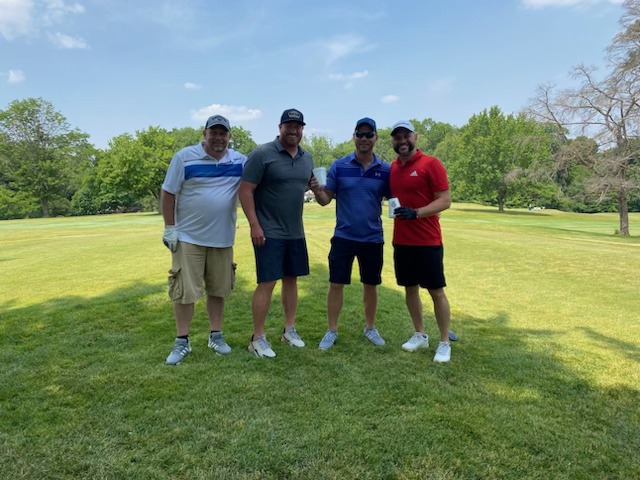 A foursome of golfers on the course