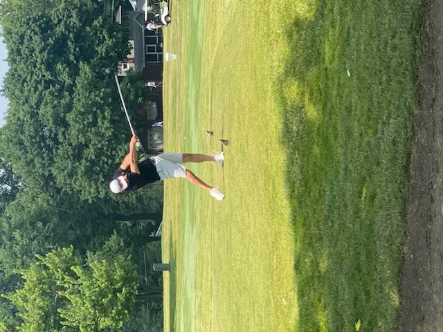 A golfer midswing